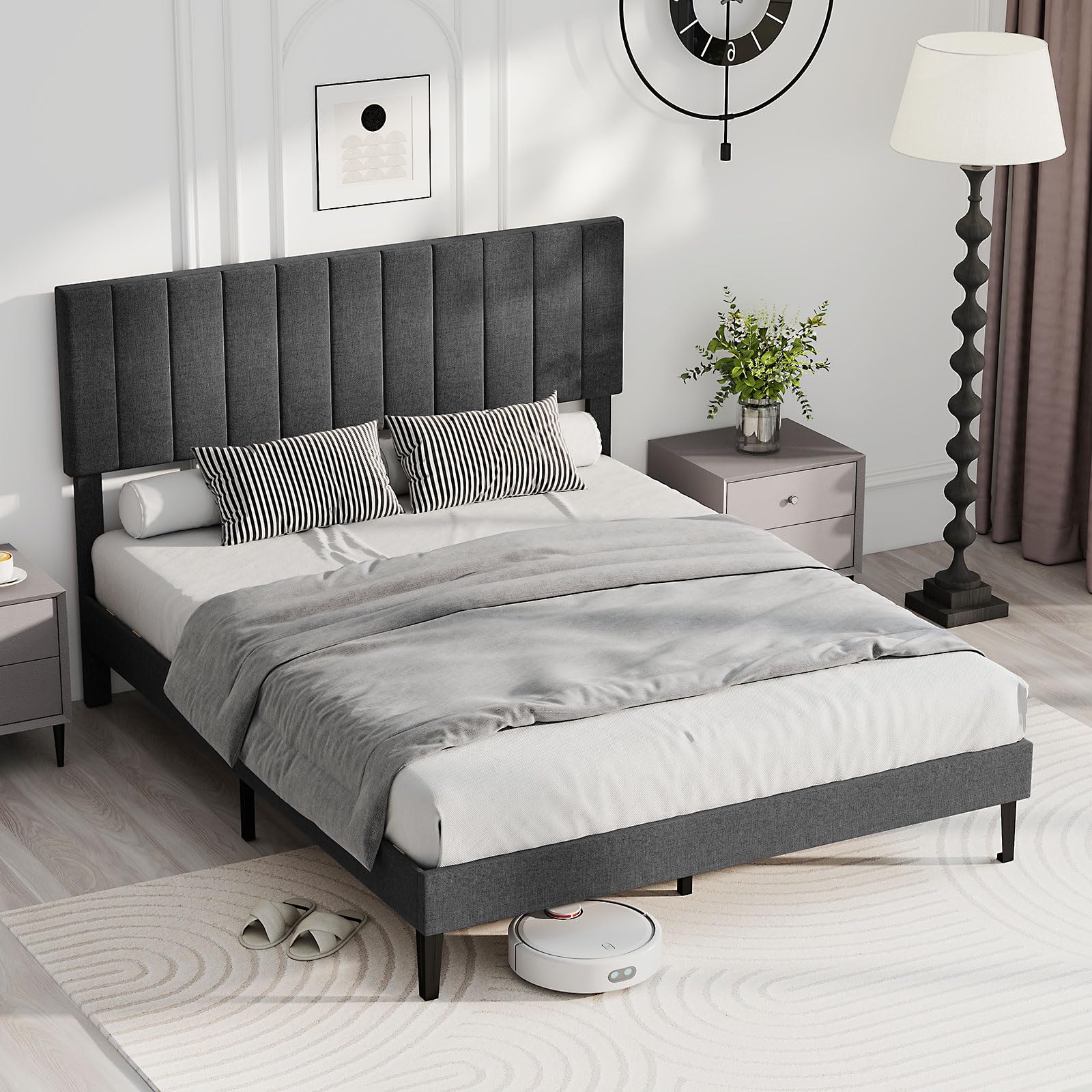 Isolated image of the bed frame without mattress, showcasing its dark grey fabric and slim legs.